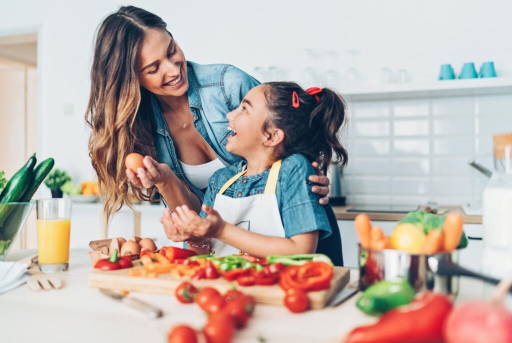 a mother and daughter making food together in the kitchen after seeing Centred Nutrition Collective dietitians