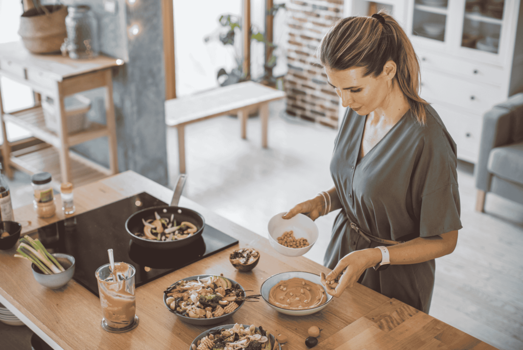 side view of a women making an iron-rich meal to get more nutrients for perimenopause