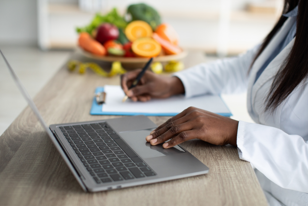 close up of a dietitian vs nutritionist at her laptop