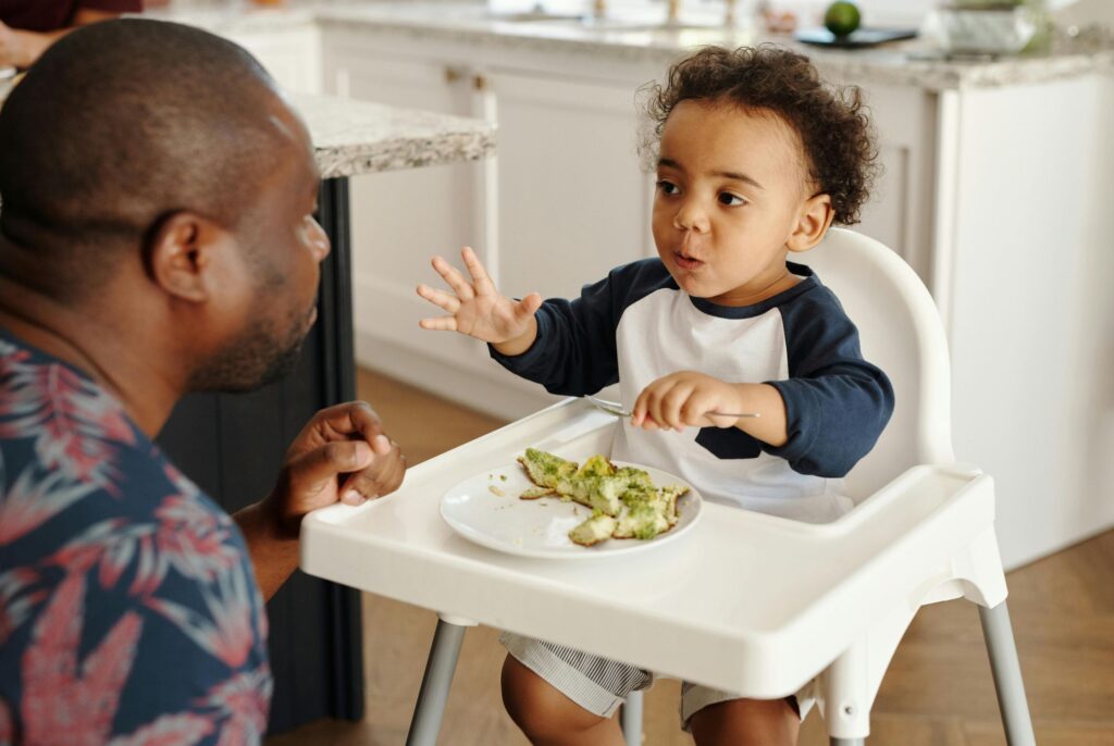 close up of father and son trying to introduce allergens to your baby