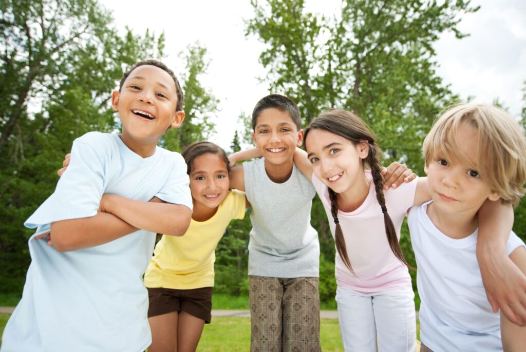 a bunch of kids happy and smiling at the camera