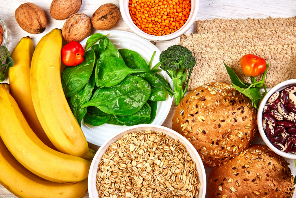 top down view of a bunch of high-fibre foods including fruits, veggies, nuts, seeds, breads