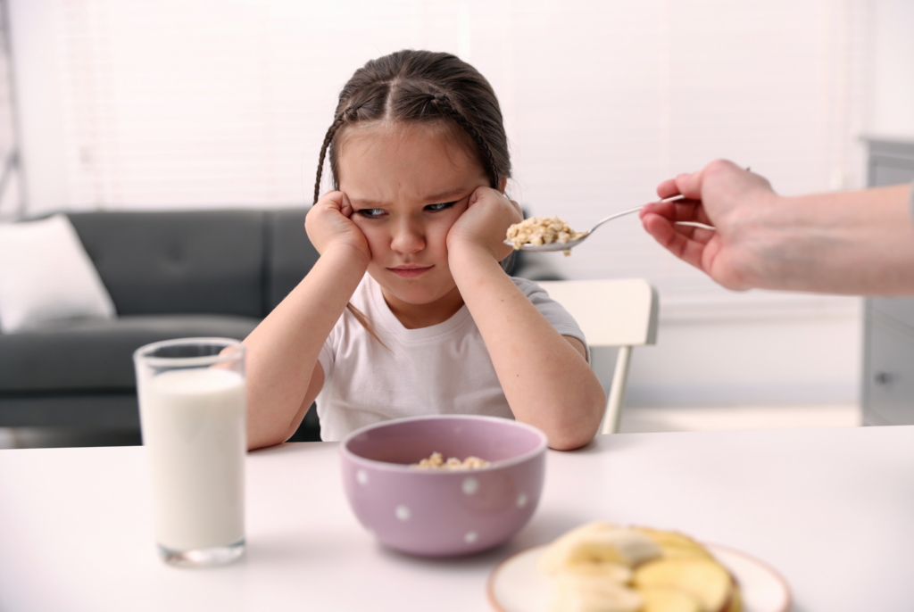 child with sensory challenges at mealtime refusing to eat cereal and mixed textures