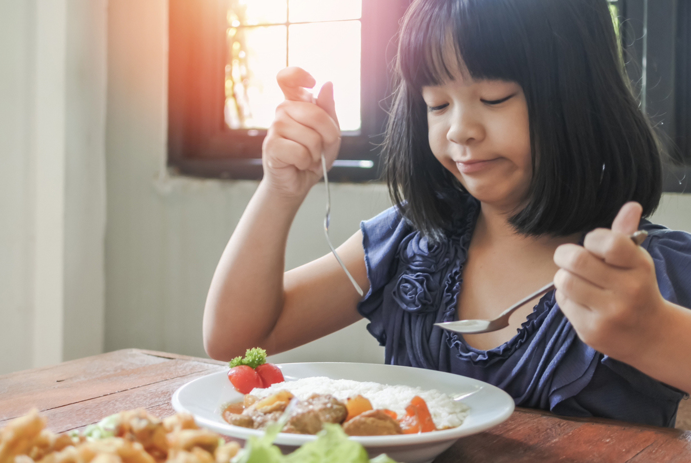 Asian kid, school girl child, picky eater with Anorexia, Bulimia Nervosa; eating problem, avoidant restrictive food intake disorder (ARFID), losing appetite with disliked healthy food meal