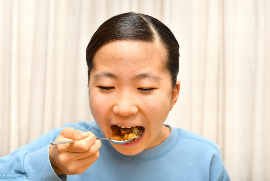 close up of mom modeling to her kids what she is eating