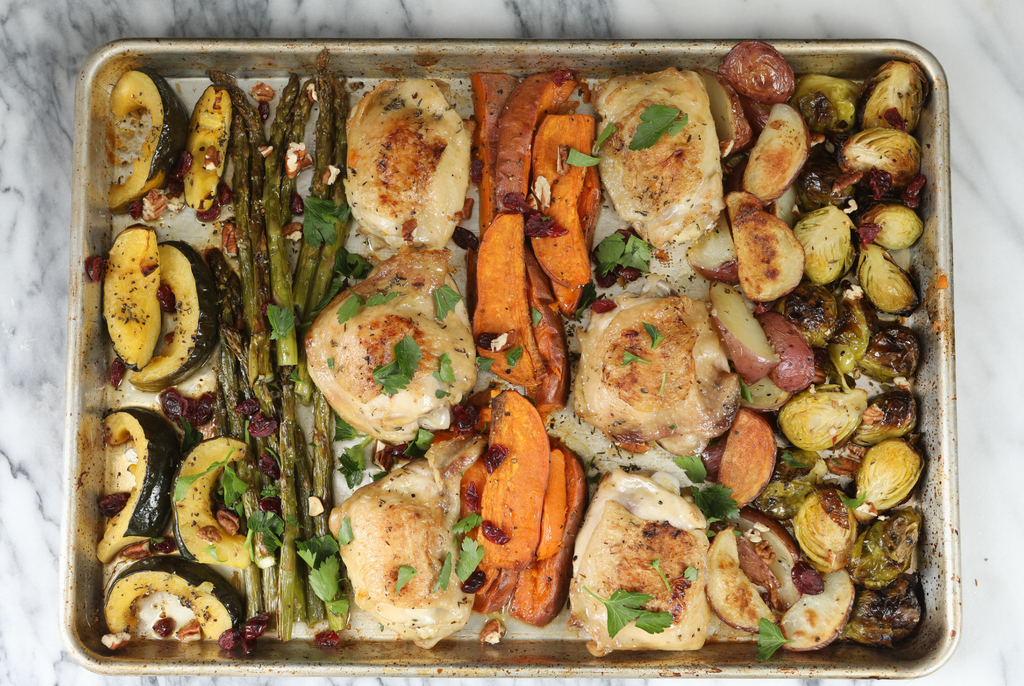 top down view of a sheet pan dinner including chicken, veggies roasted