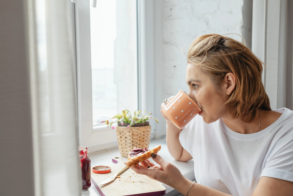 a woman sitting down for breakfast experiencing food noise thoughts