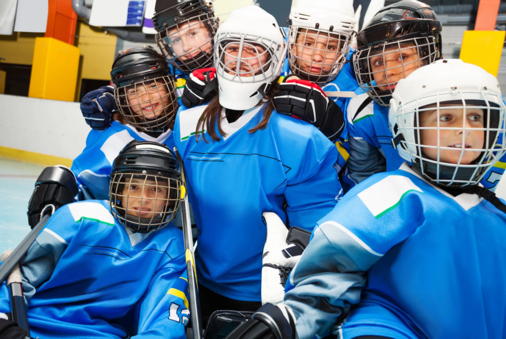 a bunch of young hockey players in their gear on the ice