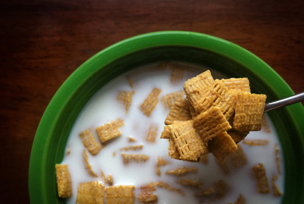 close up of a bowl of cereal with milk which is a great snack for after school sports